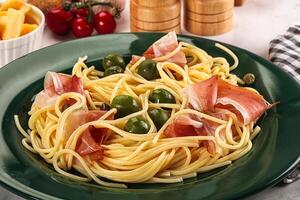 Pasta spaghetti with olives and jamon photo