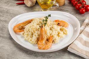 Italian risotto with prawn served thyme photo