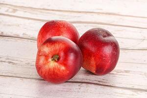 Ripe sweet juicy nectarines heap photo