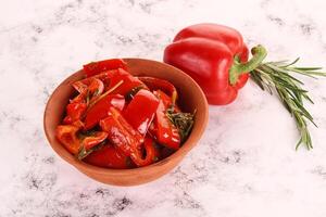 Pickled red bell pepper in the bowl photo