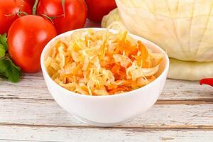 Fermented cabbage sauerkraut in the bowl photo