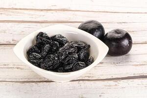 Dry prunes in thw bowl photo