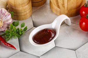 Tasty barbecue sauce in the bowl photo