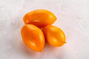 Ripe juicy yellow tomato heap photo