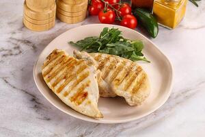 Grilled chicken breast served arugula photo