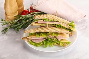 Homemade club sandwich with ham and cheese photo