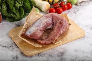 Uncooked raw pork tenderloin with spices photo