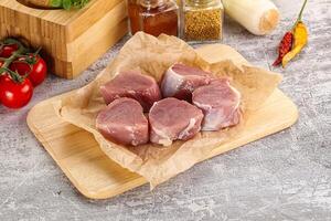 Uncooked raw pork tenderloin medallions photo