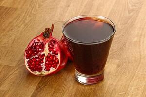 Sweet pomegranate juice in glass photo