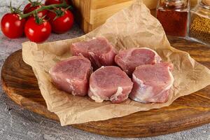 Uncooked raw pork tenderloin medallions photo