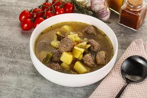 Soup with meatball and potato photo