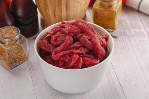 Raw beef meat - sliced strips photo