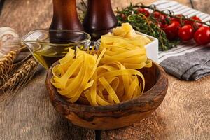 Raw dry Italian pasta - pappardelle photo