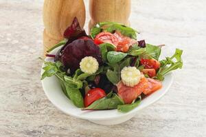 Mix salad with salmon, corn and tomato photo