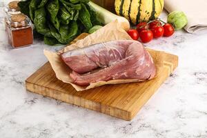 Uncooked raw pork tenderloin with spices photo