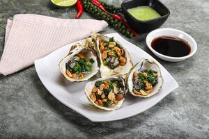 Open half oysters with green onion photo