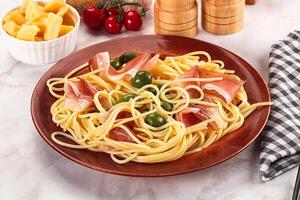 Pasta spaghetti with olives and jamon photo