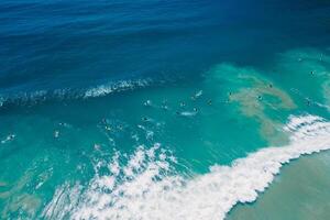 Surfers in ocean on surfboard and waves. Aerial view photo