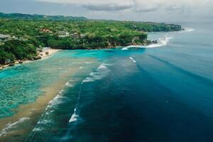 Aerial view of ocean with waves and coastline on Padang Padang beach in Bali photo