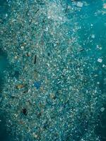 Ocean and plastic trash, aerial view. Pollution by plastic rubbish photo