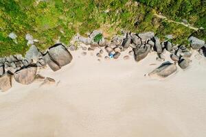 Amazing beach in tropics with umbrella and stones rock. Aerial view. Top view photo