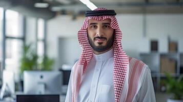 Confident Middle Eastern Businessman in Traditional Clothing in a Modern Office Setting Professional Corporate Environment photo