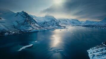 Vast liquid surrounded by snowcapped mountains in a stunning natural landscape photo