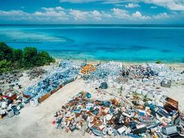 Rubbish dump and blue ocean in Maldives. Drone view photo