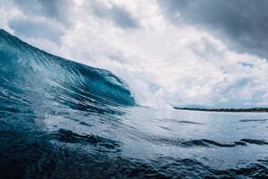 Big ocean blue wave. Breaking barrel wave photo