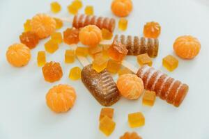 Homemade marmalade with juice mandarin fruits. Flat lay, top view photo