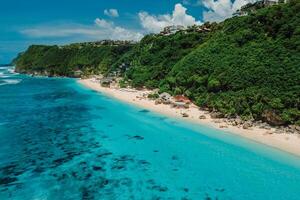 Tropical holidays beach with turquoise ocean in Bali. Aerial view of popular touristic beach photo