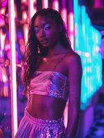 A woman in a crop top and skirt posing in front of a neon sign photo