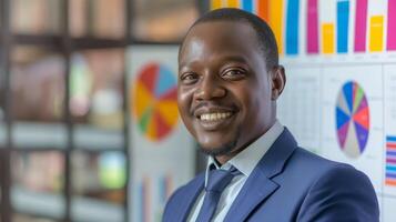 Confident African Businessman Smiling in Office, Charts and Reports in Background, Symbolizing Business Success and Growth photo