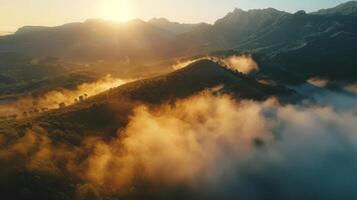 Aerial view of a mountain range with sunlight breaking through clouds in the sky photo