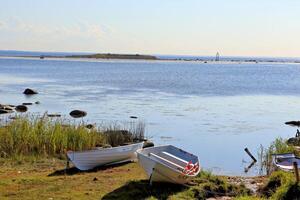 stones in the water, old wooden pier with boats photo