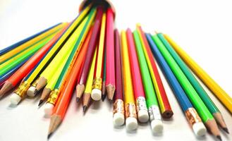 Pencils of different colors on table background photo