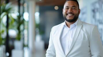 Confident Professional Man in Modern Office Setting, Smiling Portrait in White Suit for Business Promotional Use photo