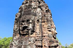 Bayon temple in Cambodia, faces of unknown deities photo