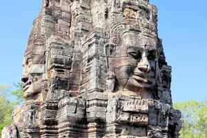 Bayon temple in Cambodia, faces of unknown deities photo