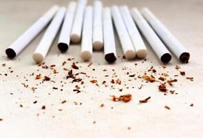 Cigarettes lie on the table, tobacco crumbs photo