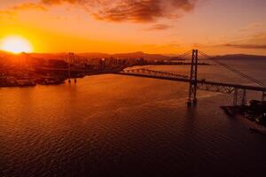 Aerial view of Hercilio luz cable bridge with sunset in Florianopolis, Brazil photo