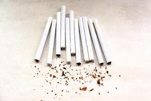 Cigarettes lie on the table, tobacco crumbs photo
