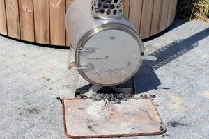 Sauna barrel with a firebox for swimming on the seashore photo