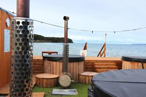 Sauna barrel with a firebox for swimming on the seashore photo