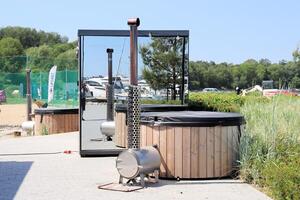 Sauna barrel with a firebox for swimming on the seashore photo