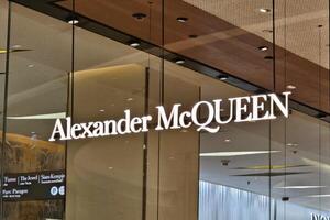 Bangkok, Thailand DECEMBER 21, 2023 Alexander McQueen sign. It is a British luxury fashion house founded by the designer Alexander McQueen in 1992. photo