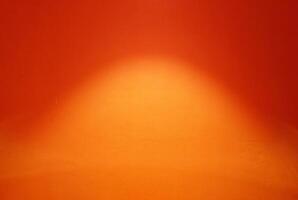 Spotlight on the surface of orange painting concrete wall background. photo