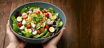 A bowl of healthy salad is served on wooden background photo