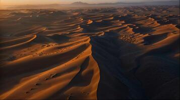 Aerial view of desert landscape with mountains and valleys at sunset photo