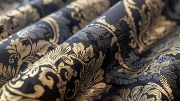 Closeup of a black and gold floral pattern on fabric photo